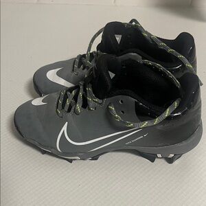 Nike Gray Cleats with White Swoosh and Green-Laced Detail